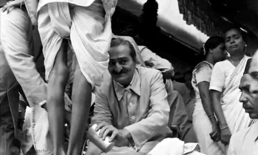 Meher Baba washing the feet of the poor in India